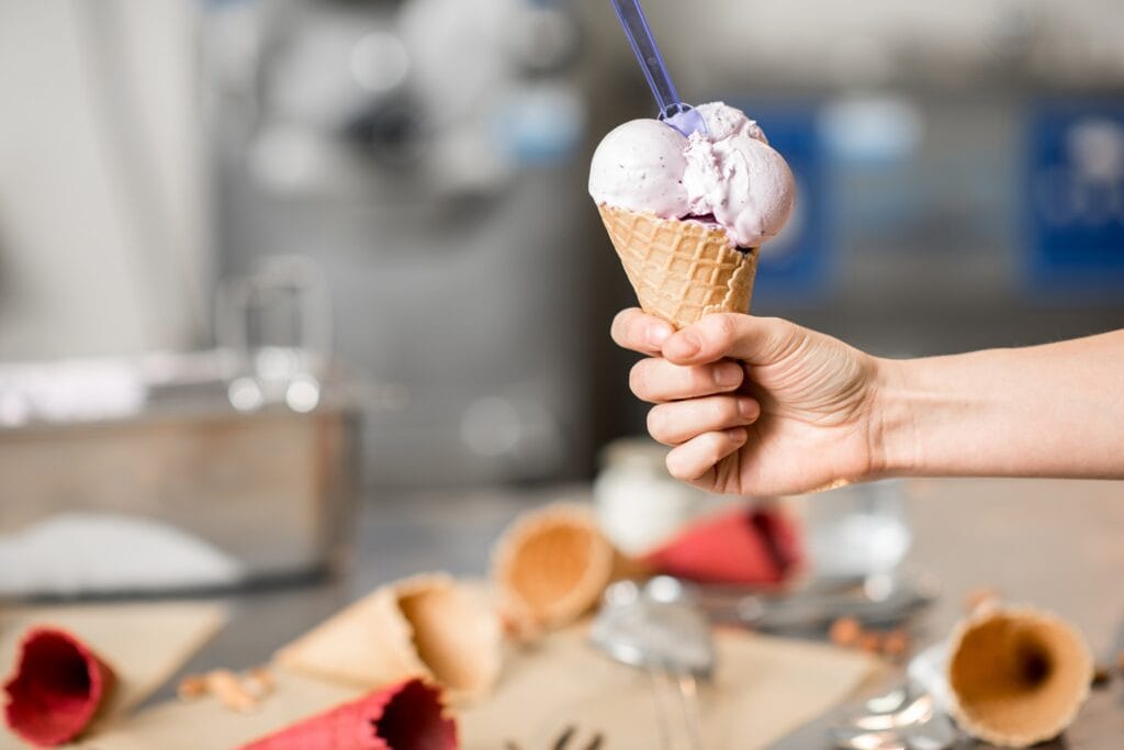 holding waffle cone with ice cream indoors 2025 03 13 21 53 24 utc