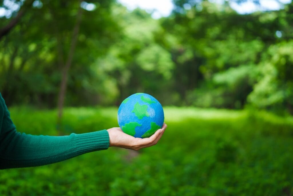 an asian woman holds a globe in green forest symbo 2025 02 15 11 54 43 utc
