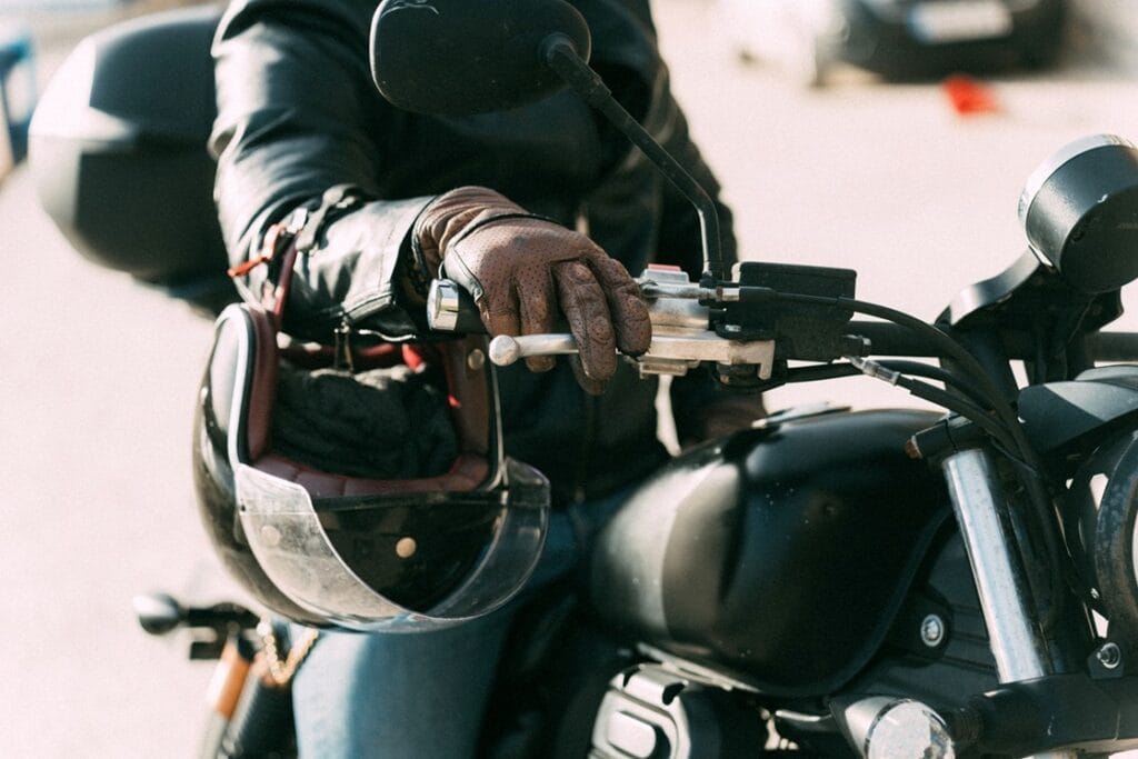 biker wearing leather gloves is starting his motor 2025 03 15 03 44 28 utc