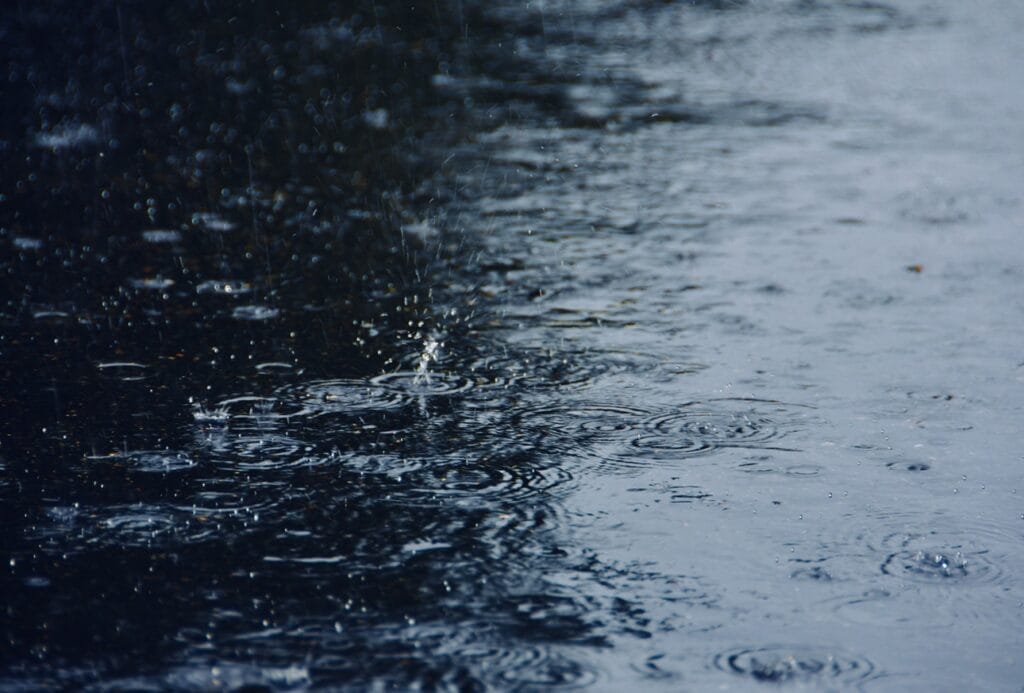 raindrops splashing into flooded pavement 2024 12 02 02 45 27 utc