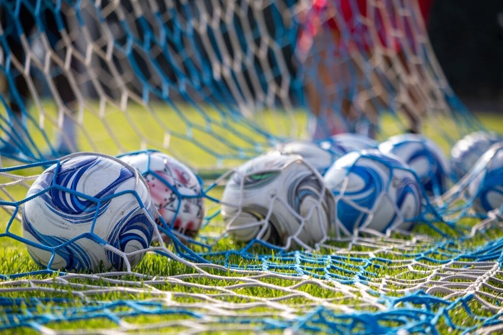 soccer ball on field behind view of net and footb 2024 12 07 20 15 52 utc