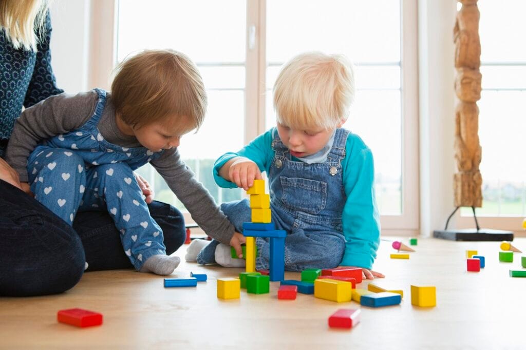 mid adult woman and two toddlers playing with buil 2025 04 04 18 39 43 utc