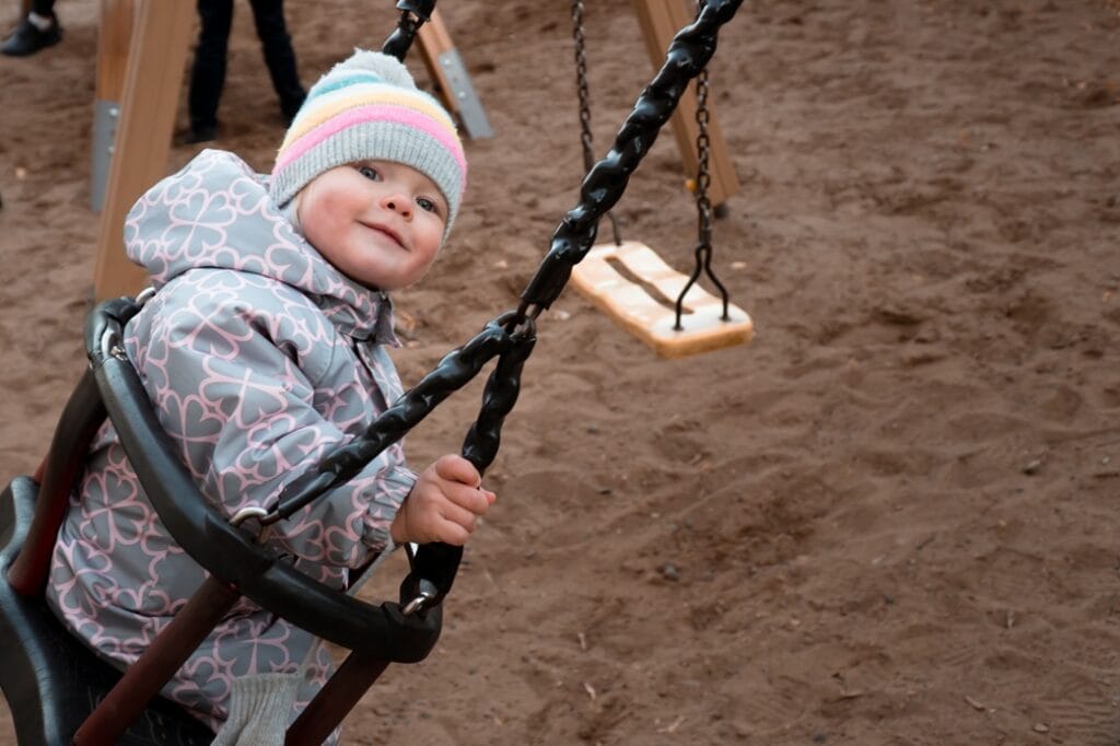 baby on swing in winter clothes 2025 03 08 14 53 45 utc