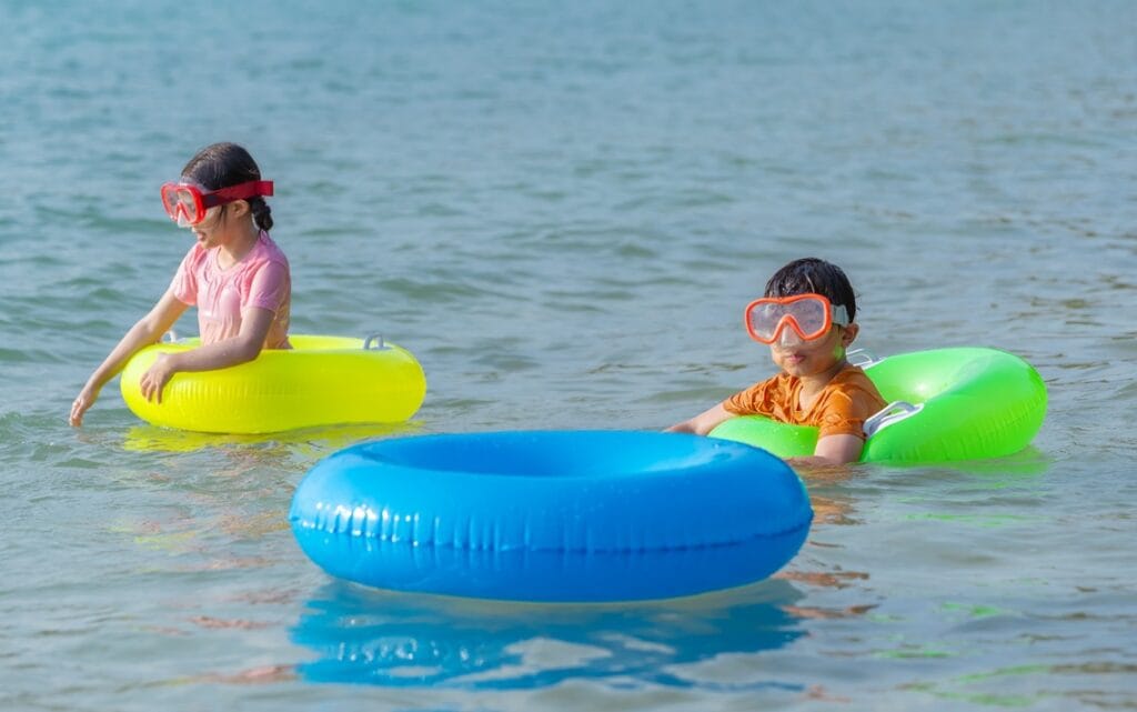 children playing colored inflatable rings joyful b 2025 08 04 22 26 13 utc