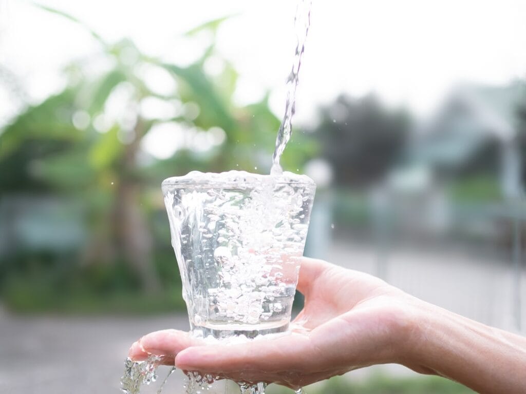 pouring water in glass on palm up women with blur 2025 02 22 07 04 41 utc