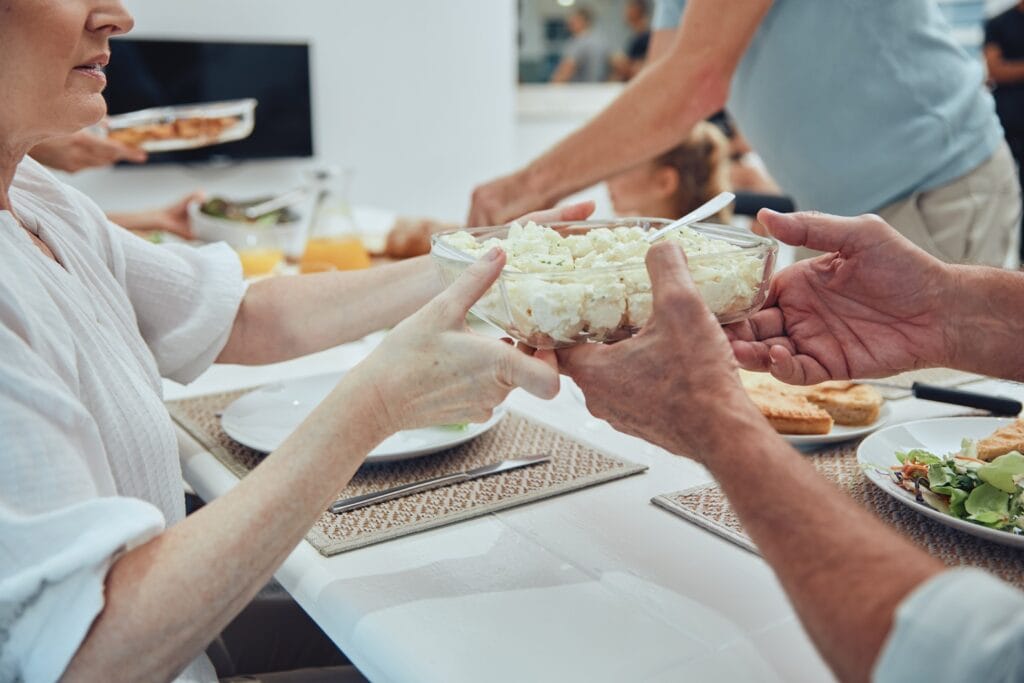hands lunch and potato salad in family home for h 2025 04 06 12 36 09 utc
