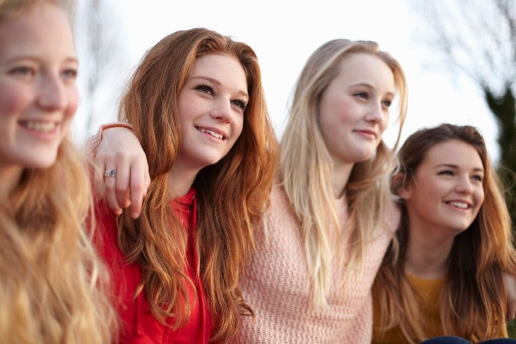 friends smiling together outdoors in sunlight 2026 03 11 00 58 03 utc