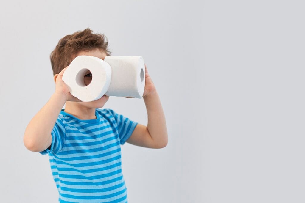 playful boy holding toilet paper rolls as binocula 2026 01 08 06 03 47 utc