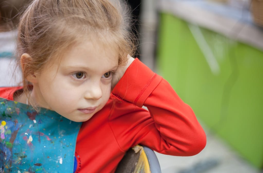pensive child resting head indoors wearing artist 2026 03 26 07 51 15 utc