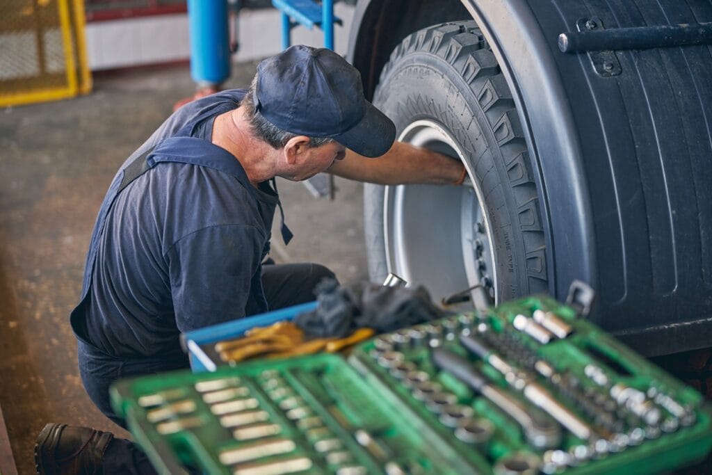 mechanic working on tire in a garage 2026 03 20 04 26 48 utc